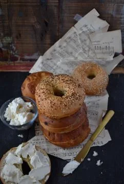 Assorted Bagels with cream cheese on rustic table with music sheets Stock Photos