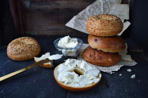 Assorted Bagels with cream cheese on rustic table Stock Photos