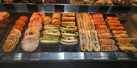 Assorted baked goods displayed in a bakery showcasing various pastries Stock Photos