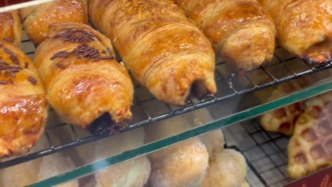 Assorted bakery pastries donuts waffles and pisang bolen display 스톡 동영상 341897876