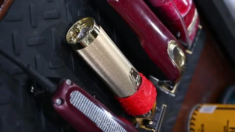 Assorted barber clippers on textured mat Stock Footage 267606917