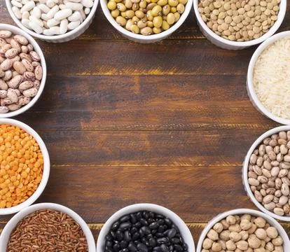 Assorted beans and grains on white bowls with copy space Stock Photos