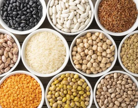 Assorted beans and grains on white bowls Stock Photos