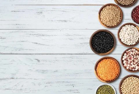 Assorted beans over wooden table with copy space Stock Photos