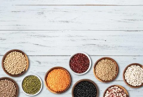 Assorted beans over wooden table with copy space Stock Photos