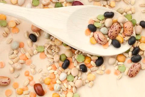 Assorted beans in wooden spoon Stock Photos