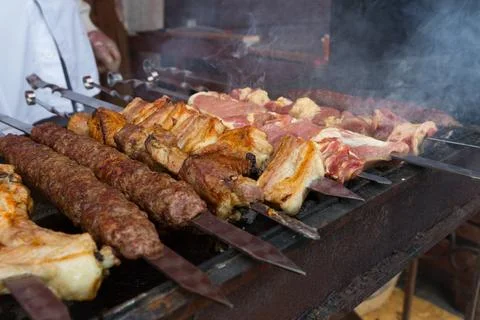 Assorted Beef, Pork and Chicken Skewers Grilling on Charcoal 스톡 사진