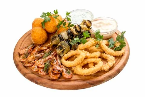Assorted beer snacks. Cheese balls, mussels grill, shrimp, squid rings. Stock Photos