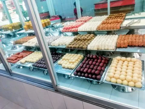 Assorted Bengali Sweets and Ghee Jars on Display in a Local Dhaka Sweet Shop Stock Photos