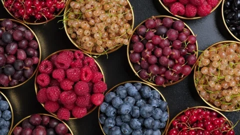 Assorted Berries and Cherries Rotating in Golden Bowls Stock Footage 346251587