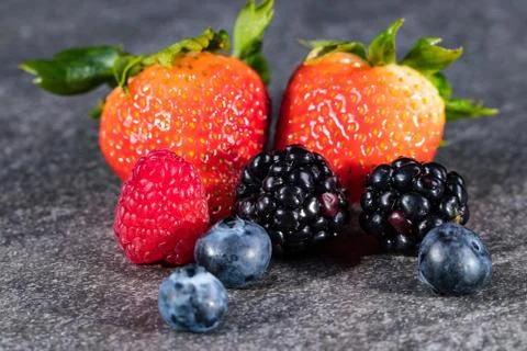 Assorted berries on gray stone 写真素材