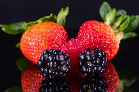 Assorted berries isolated on black 写真素材