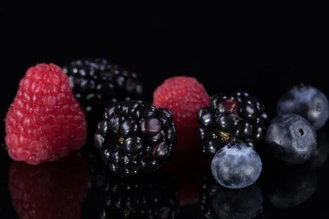 Assorted berries isolated on black 写真素材