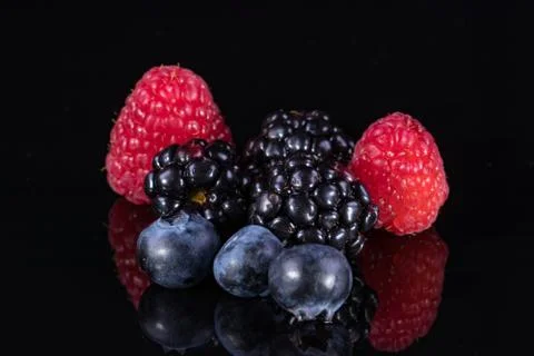 Assorted berries isolated on black 写真素材