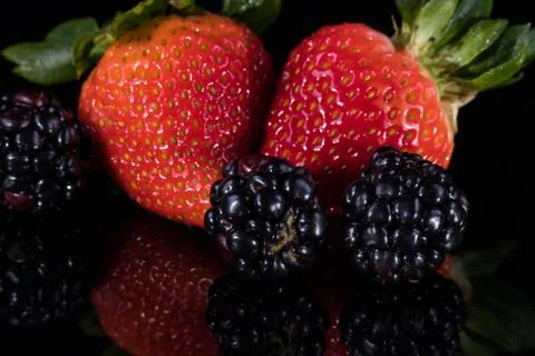Assorted berries isolated on black 写真素材