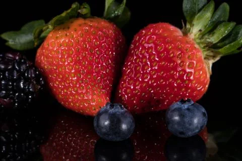 Assorted berries isolated on black 写真素材