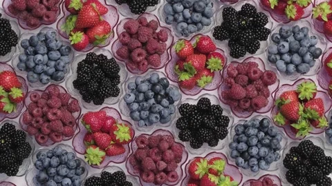 Assorted Berries Rotating in Flower Shaped Bowls Flat Lay Stock Footage 346249245