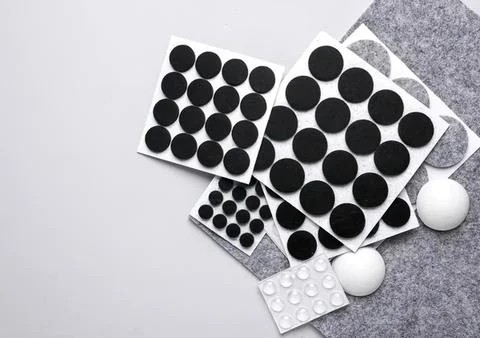 Assorted black adhesive dots and circular stickers on paper Stock Photos