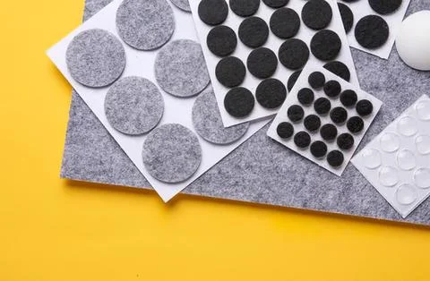 Assorted black and white adhesive dots on paper sheets Stock Photos