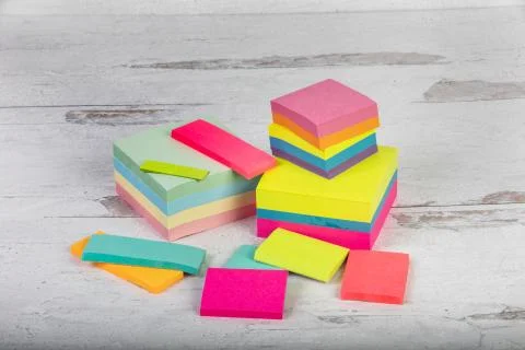 Assorted blank posted notes no words stacked on a neutral background Stock Photos