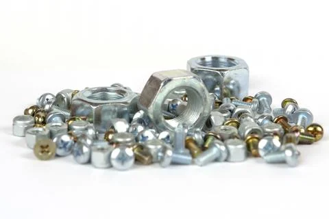 Assorted bolts and nuts on a white background 스톡 사진