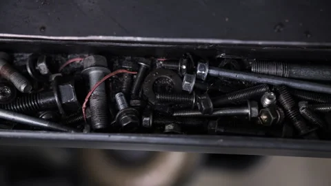 Assorted bolts and screws stored in metal workshop tray Stock Footage 310781818