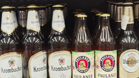 Assorted bottles of beer neatly arranged on store shelf Stockbeeldmateriaal 310406936