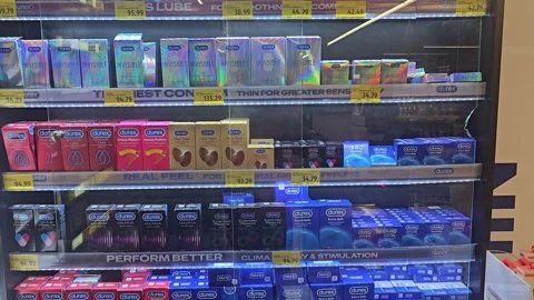 Assorted boxes of contraceptives displayed on a retail pharmacy shelf Stock-Footage 332773195