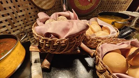 Assorted Bread Rolls &amp; Buns Displayed in Wicker Baskets at Buffet table Stock Photos