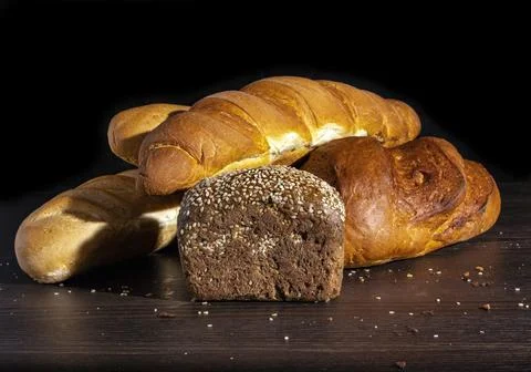 Assorted bread on a wooden table background. Stock Photos