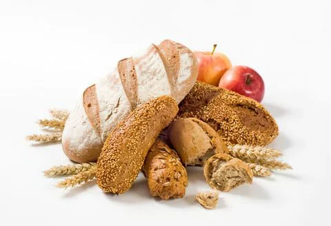 Assorted breads and apples on wheat stalks Stock Photos