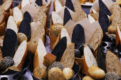 Assorted breads in a basket, multi colored bread slices Stock Photos