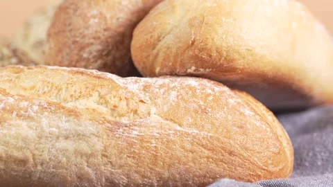 Assorted breads. Buns with seeds, baguettes, brown bread. Video stock 303632186