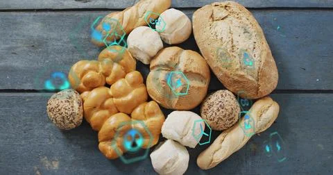 Assorted breads resting on blue-gray plank, teal holos appearing on reveal Stock Photos