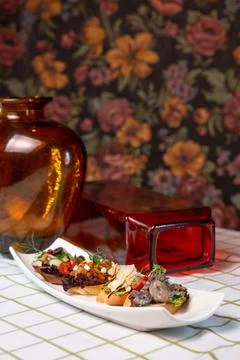 Assorted bruschetta with different flavors on a white plate on the table Foto stock