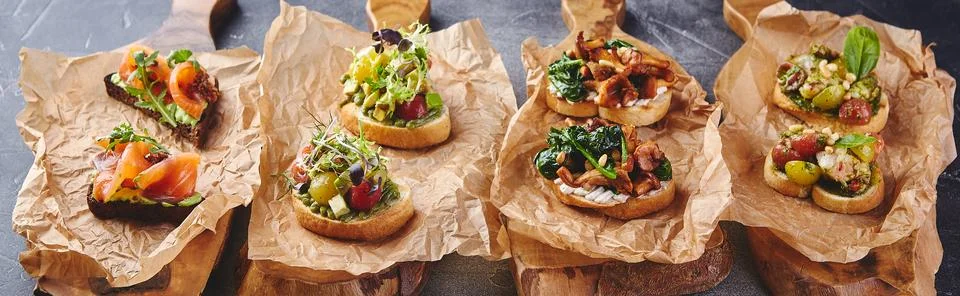 Assorted bruschettas with various fillings. Appetizing bruschetta. Variety of Stock Photos