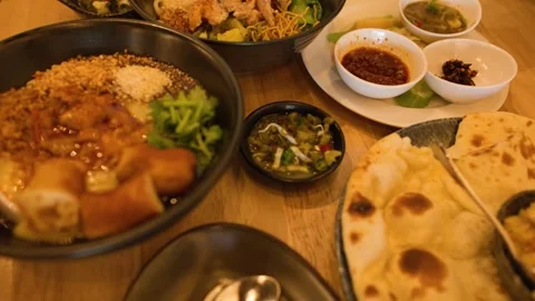 Assorted Burmese Cuisine Spread on Restaurant Dining Table Stock Footage 345715252