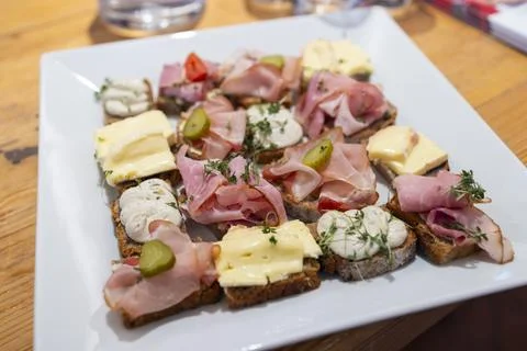Assorted canapes serving savory appetizers on a white plate 스톡 사진