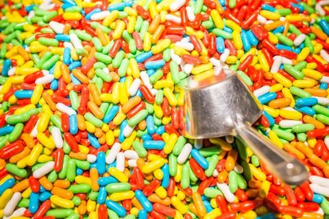 Assorted candy covered licorice with metal spoon. Stock Photos