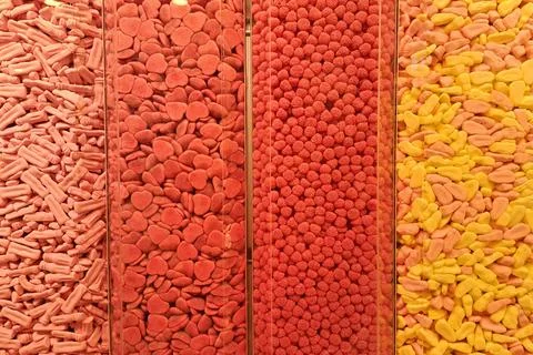 Assorted candy pieces sorted by color in clear display bins Stock Photos
