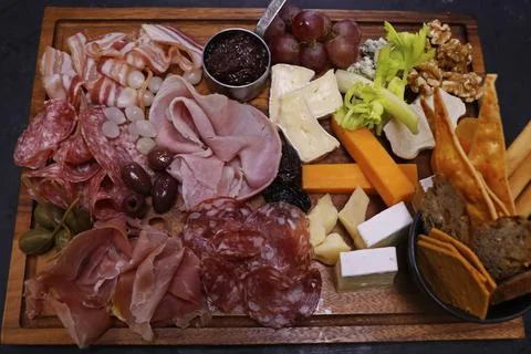 Assorted cheese and cold meat platter or board with condiments Stock Photos