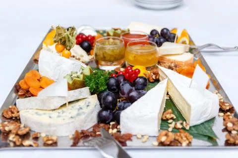 Assorted cheese and grapes Stock Photos