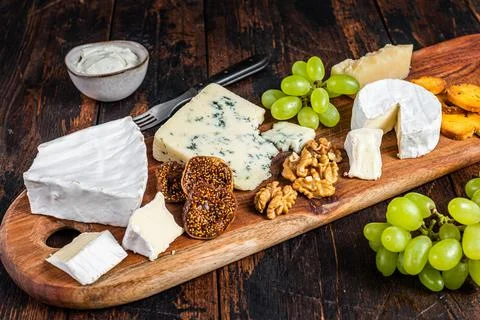 Assorted Cheese board with Brie, Camembert, Roquefort, parmesan, blue cream Stock Photos