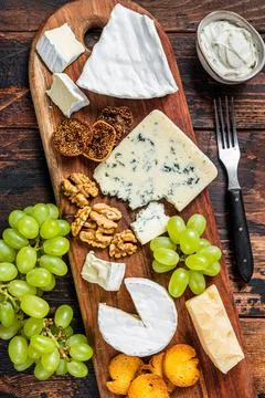Assorted Cheese board with Brie, Camembert, Roquefort, parmesan, blue cream Stock Photos