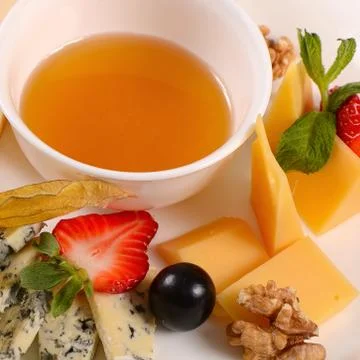 Assorted cheese with honey Stock Photos