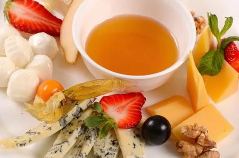 Assorted cheese with honey Stock Photos