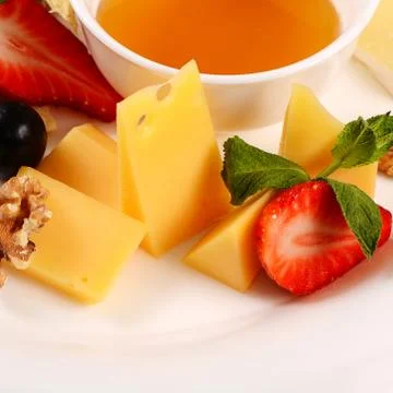 Assorted cheese with honey Stock Photos
