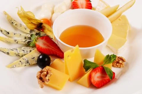 Assorted cheese with honey Stock Photos