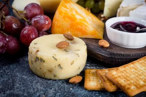 Assorted cheese pieces, jam, grapes, cookies and nuts 写真素材