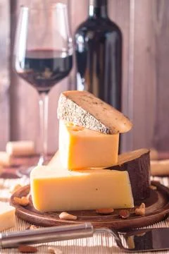 Assorted Cheese Plate with Red Wine, Nuts and Honey on wooden background 写真素材